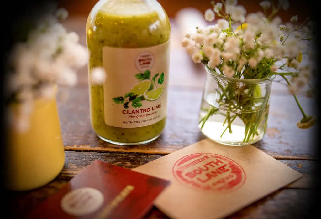 South Lane Bistro gift certificates and house dressing on a table
